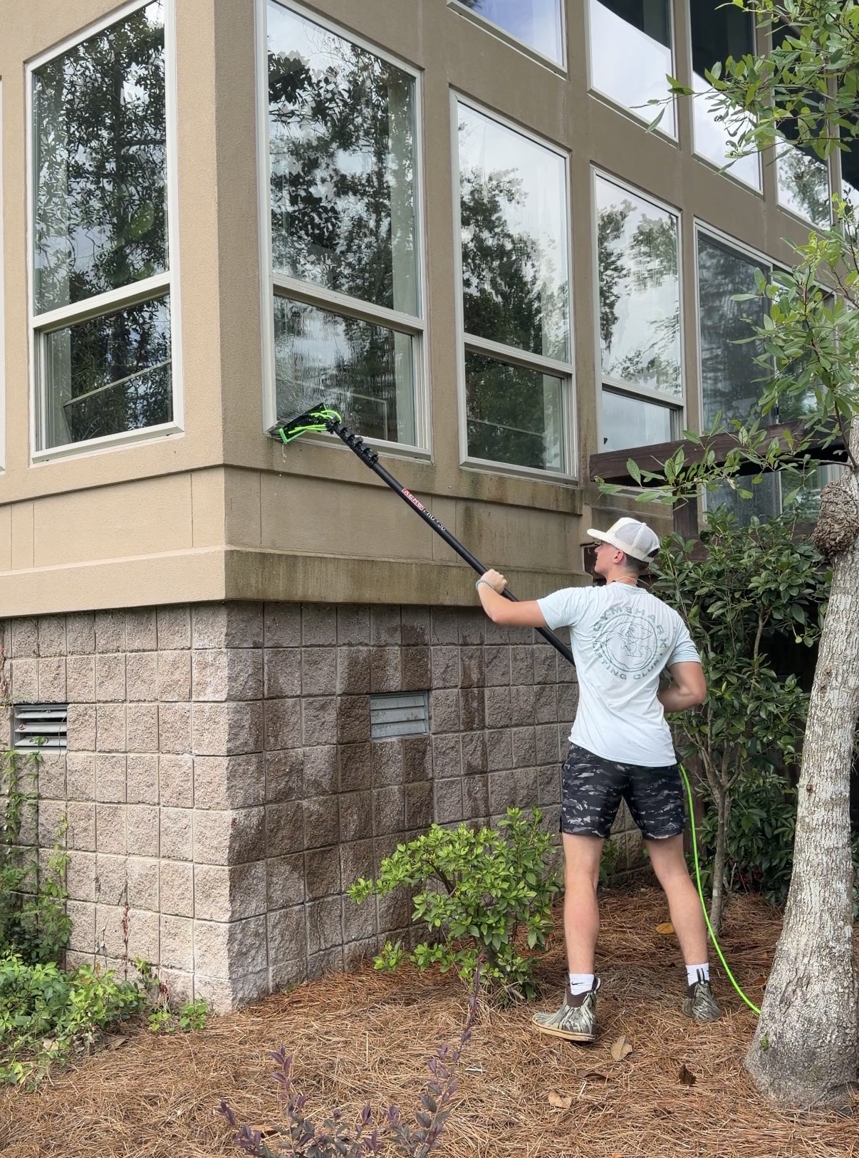 Window cleaner using a water-fed pole on a Valdosta commercial building